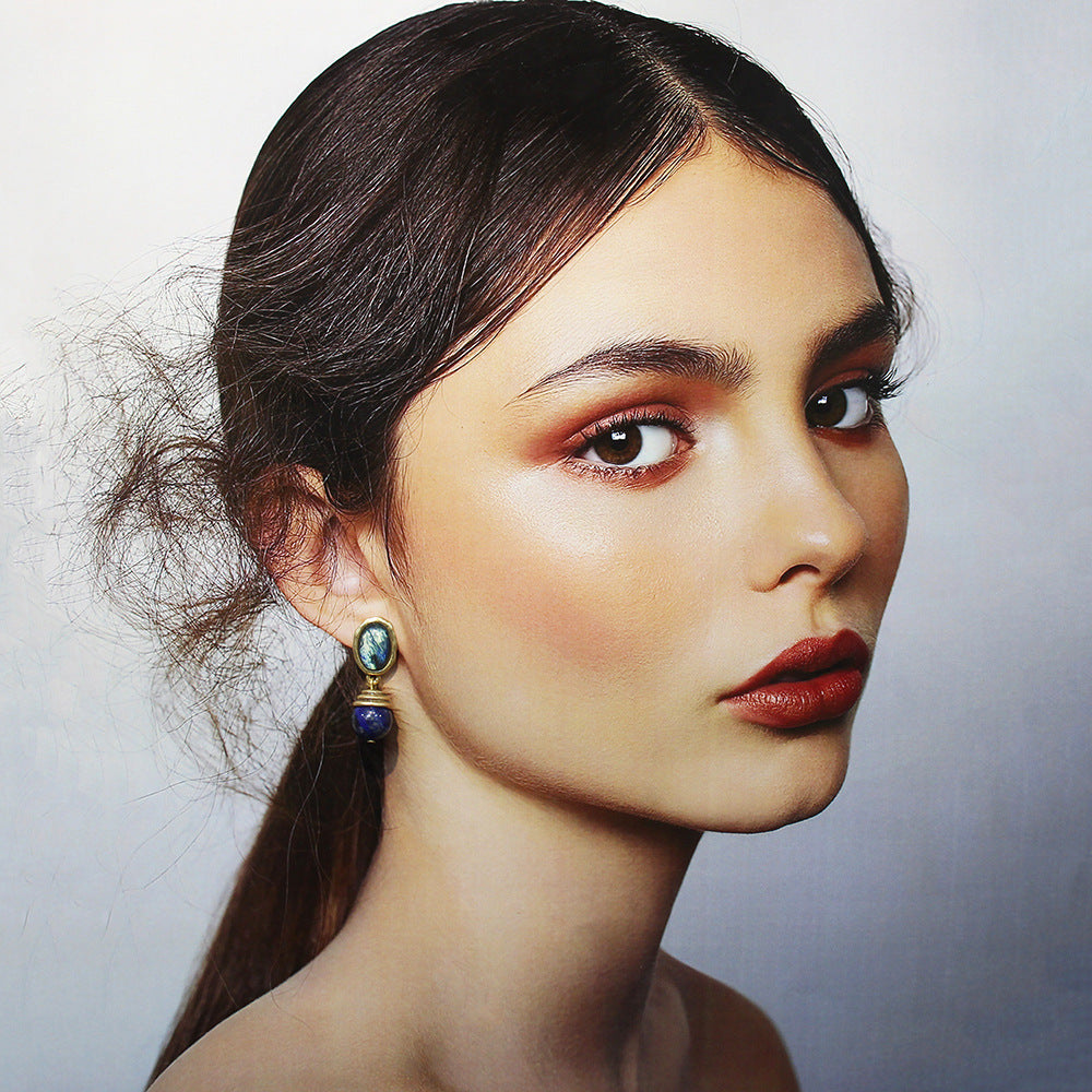 Vintage drop earrings on model: oval blue/green cabochon with blue bead