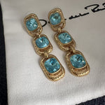Blue crystal long drop clip-on earrings, three oval stones in gold-tone frames