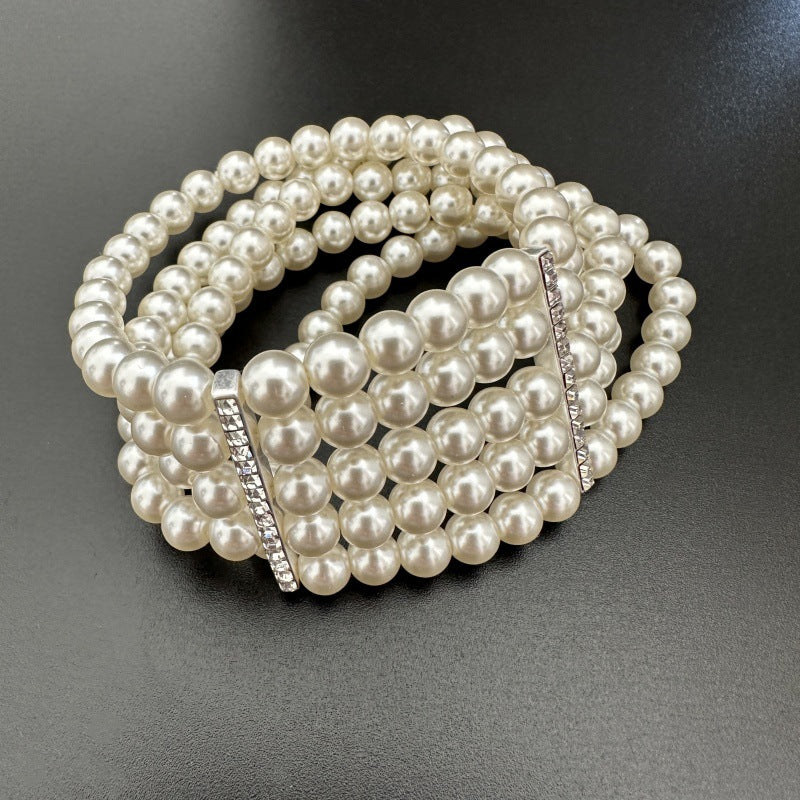 Multi-row faux pearl stretch bracelet with rhinestone bar accent