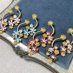 Long enamel flower hoop drop stud earrings with blue, pink, and purple blooms