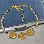 Enamel cherry blossom pendant necklace with gold-tone flowers and clear round rhinestone links