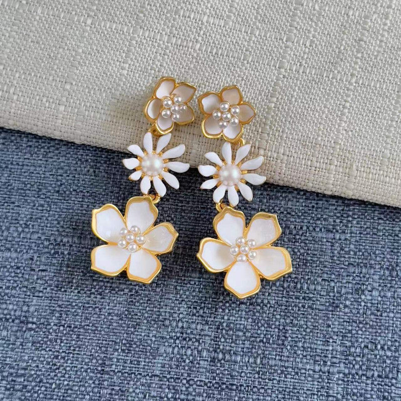 Enamel plum blossom drop earrings, white flowers with pearl centers on gold-toned drops