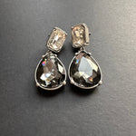 Teardrop-cut crystal stud earrings with smoky gray square tops and teardrop drops, silver tone