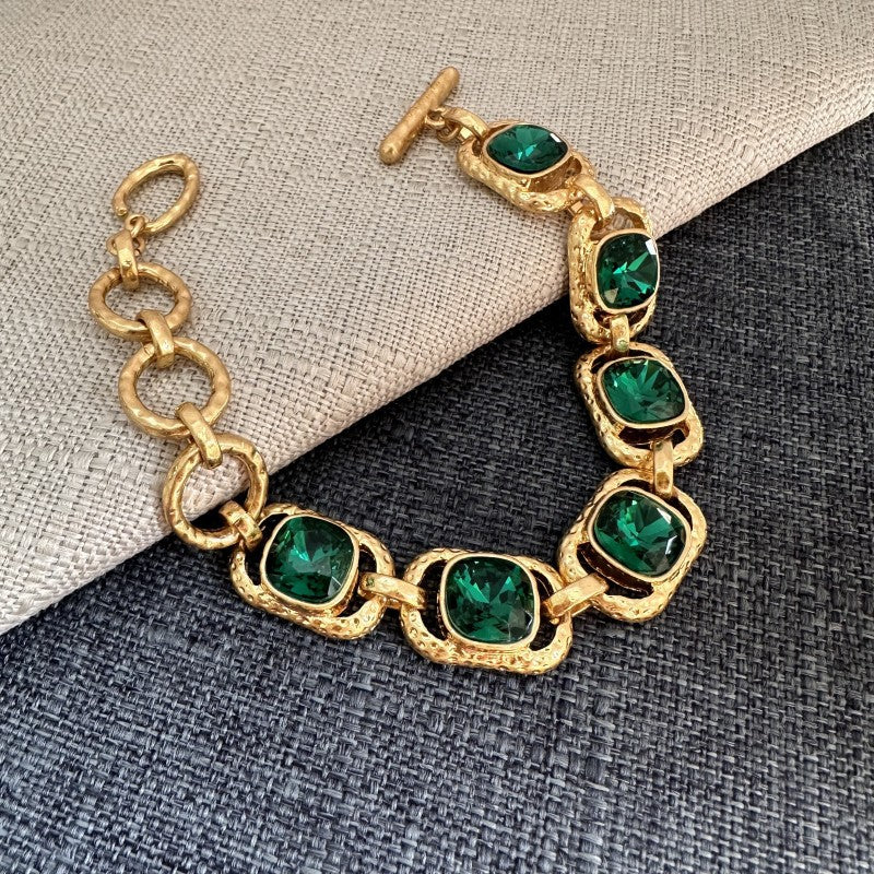 Square crystal toggle bracelet with green stones in gold square settings