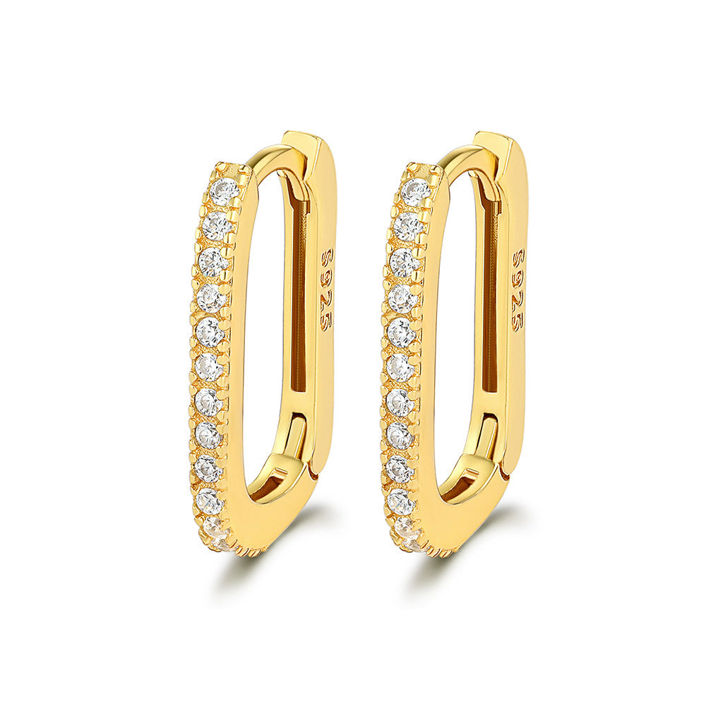 Gold U-shaped hoop earrings with clear zirconia stones along the outer edge