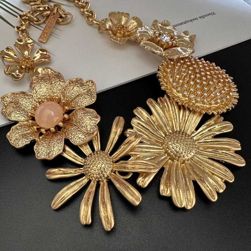 Gold-tone enamel daisy flower necklace with large textured daisy and crystal center
