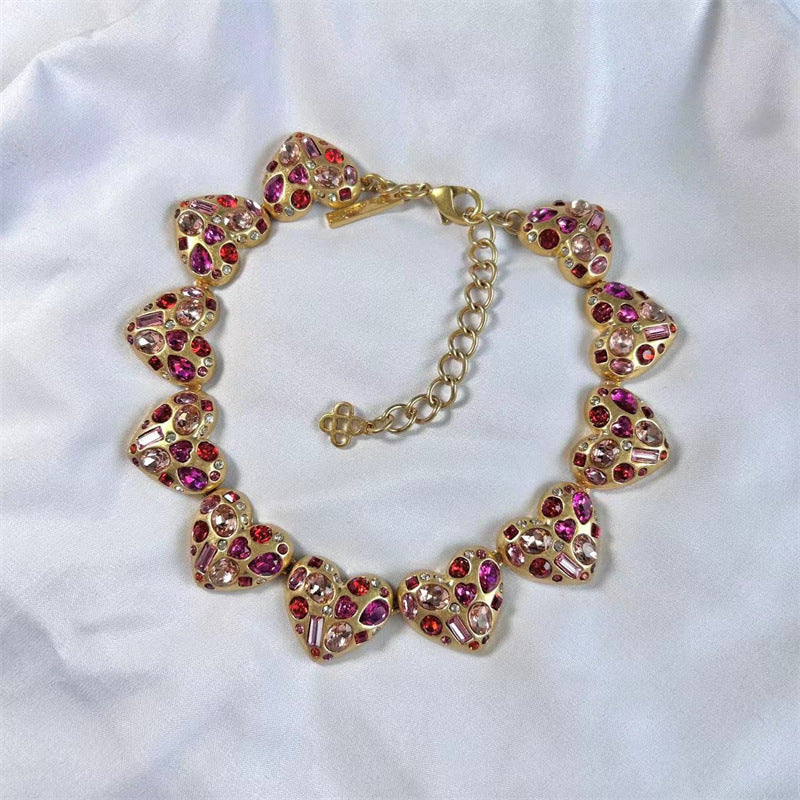 Pink crystal heart necklace with gold links and heart-shaped charms