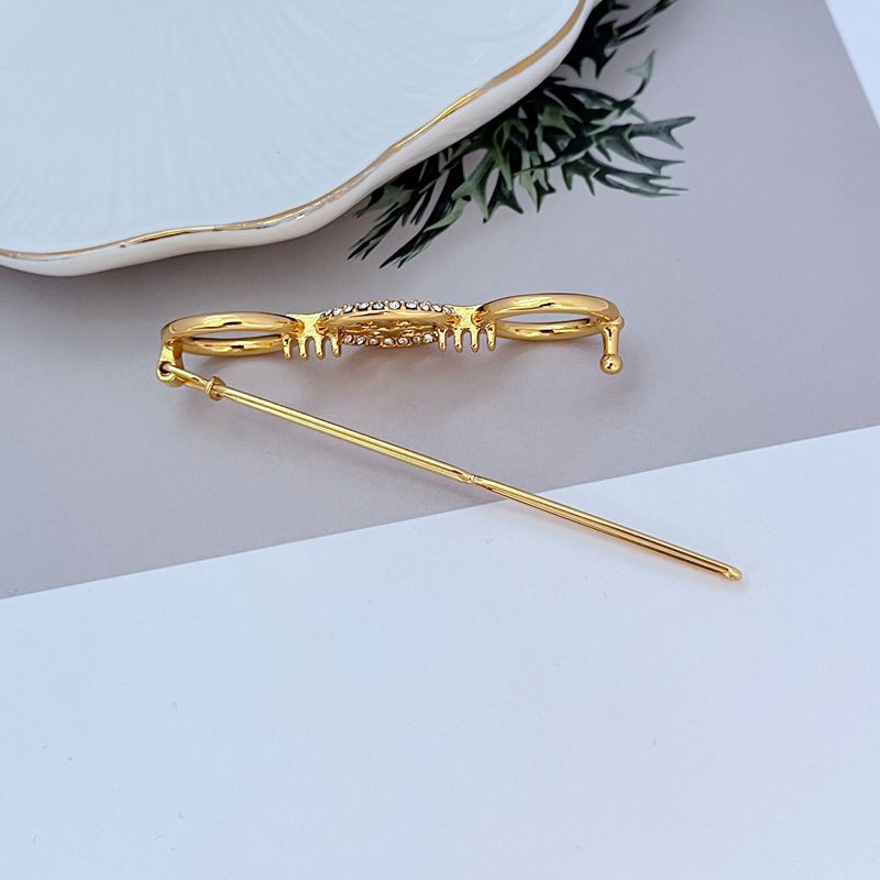 Gold metal hair clip with pavé bar detail and clasp, long pin tip