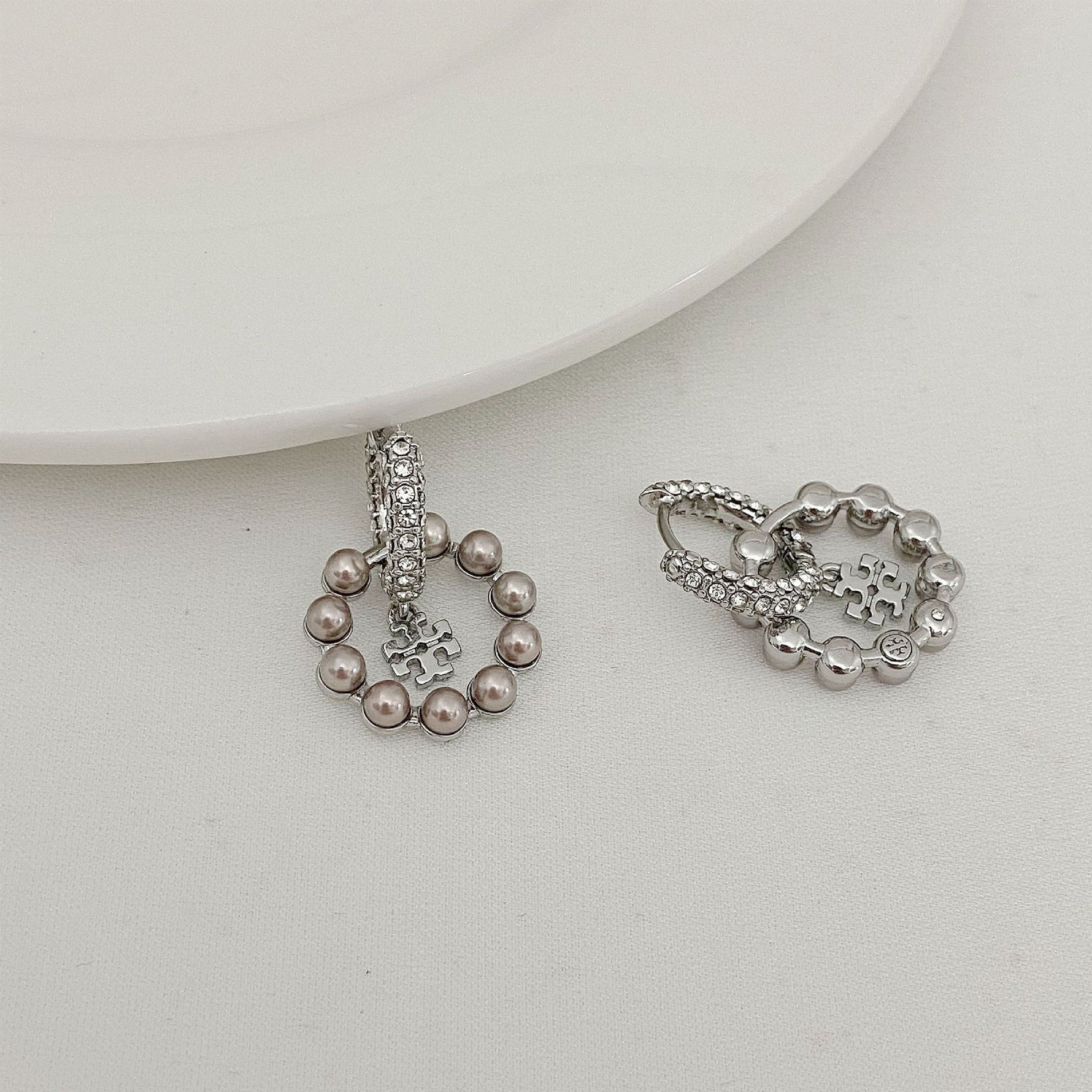Silver-tone hoop pendant earrings with rhinestones and pearl bead dangles