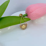 Gold dangling hoop earrings with pavé rhinestone rim and leopard-pattern center