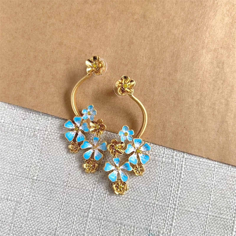 Long enamel flower hoop drop stud earrings with blue petals and gold accents