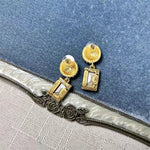 Earrings with clear rectangular stones and gold stud caps, square pendant drop