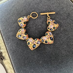Heart bracelet with colorful gemstone heart links, gold-tone clasp detail