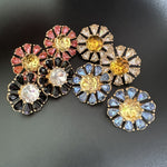 Sunburst flower stud earrings with mixed pink, yellow, black, white, and blue stones