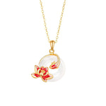 Gold-tone pendant necklace with white round chalcedony and red flower enamel on bail