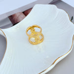 Wide polished gold ring, decorative openwork band with star center cutouts