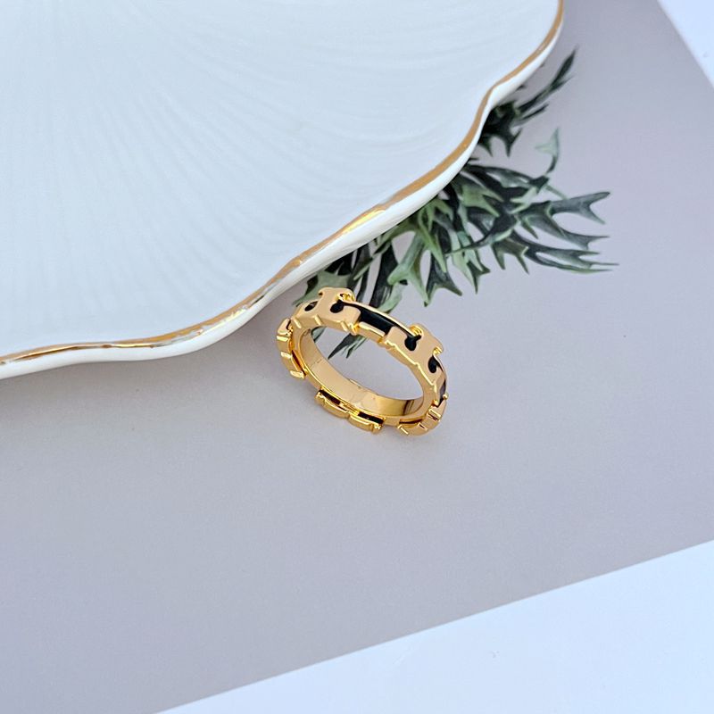 Enamel geometric circle ring with black enamel inlay on the gold-tone band