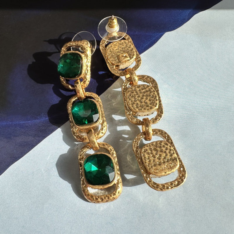 Emerald green crystal drop clip-on earrings, three faceted oval stones in gold-tone settings