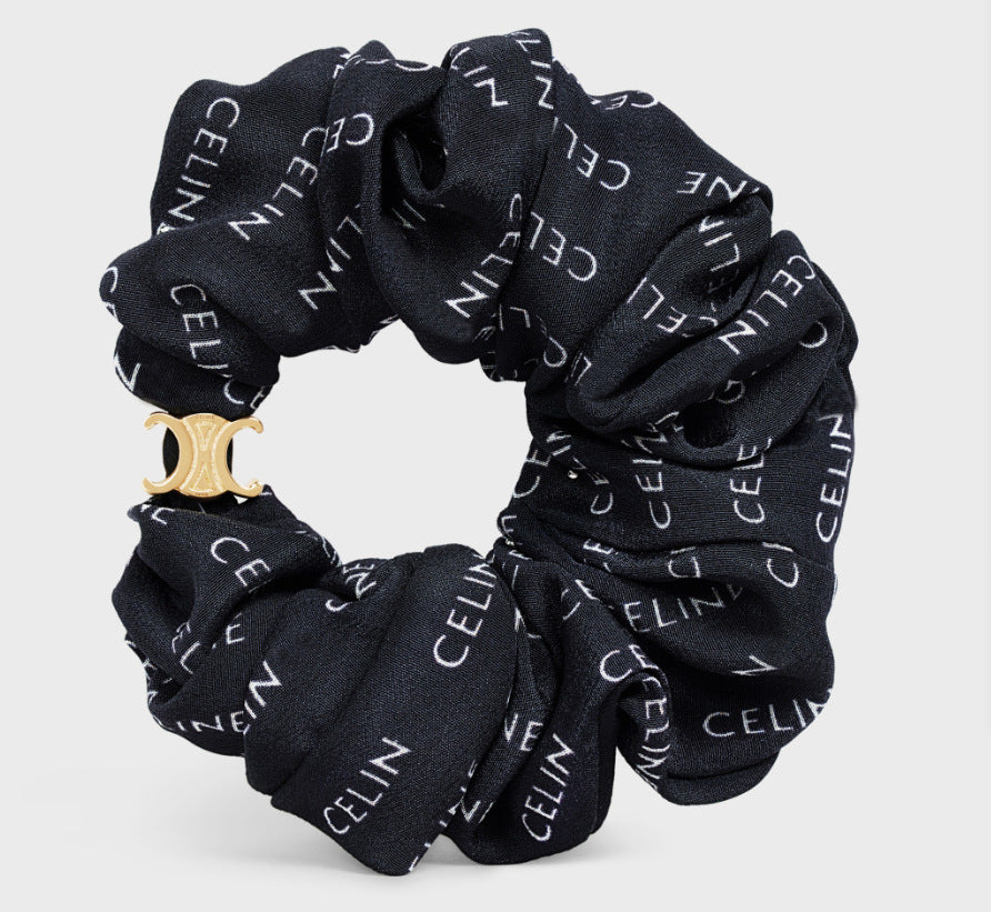Fabric hair tie, black with white CELIN text pattern scrunch bow and gold-tone charm