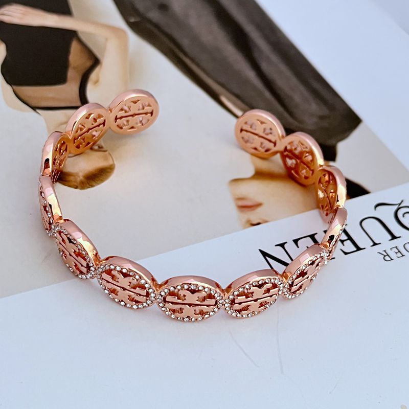 Rose-gold circular openwork logo bangle with pave diamond-studded links