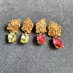 Crystal drop earrings with gold-tone caps and green or red stones