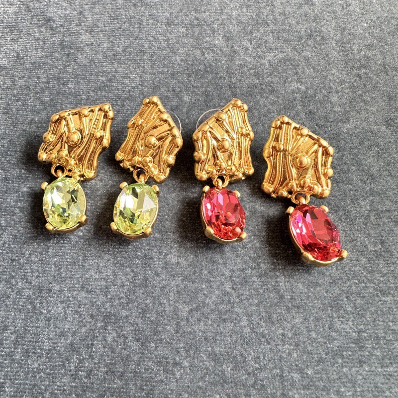 Crystal drop earrings with gold-tone caps and green or red stones