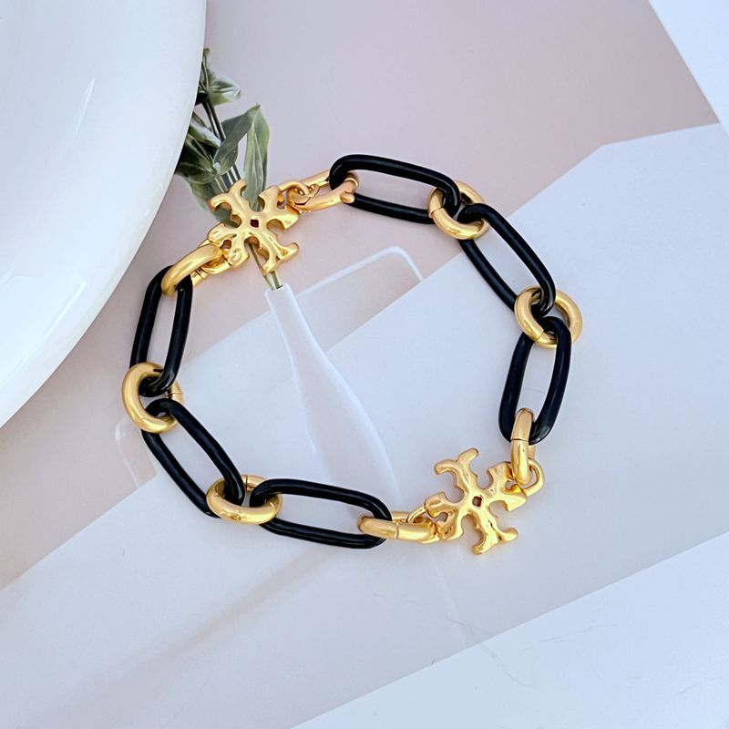 Black chunky chain bracelet with gold-tone logo charms and alternating linked segments