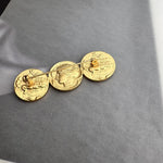 Ancient coin brooch with three matte gold coin discs on a linked bar