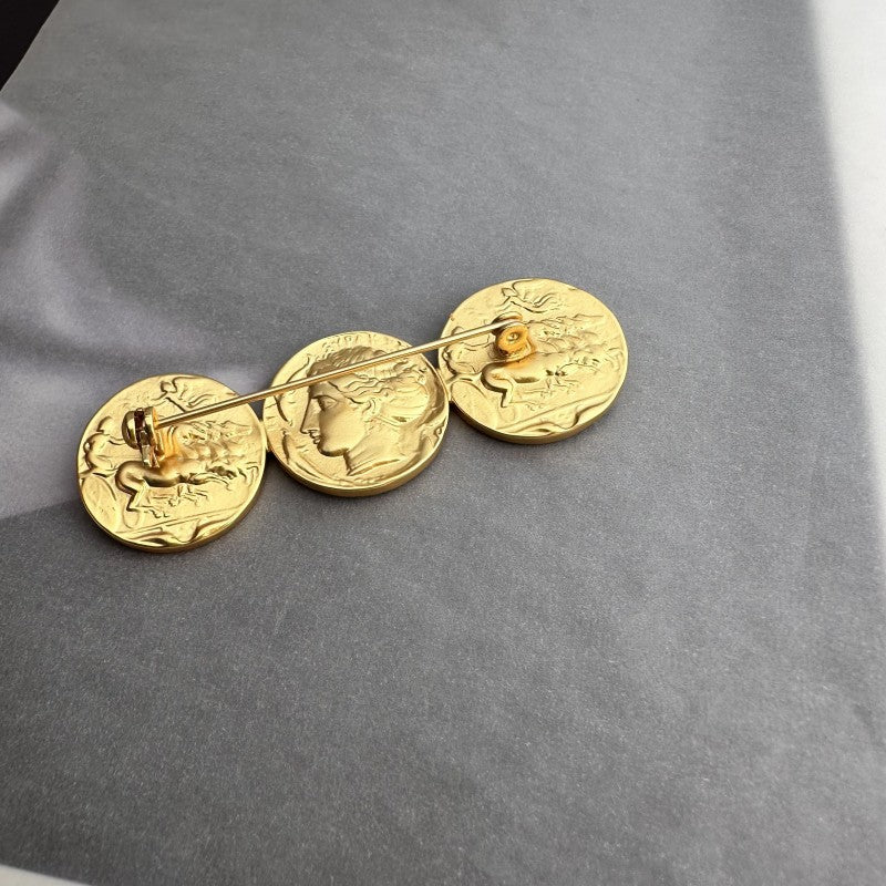 Ancient coin brooch with three matte gold coin discs on a linked bar