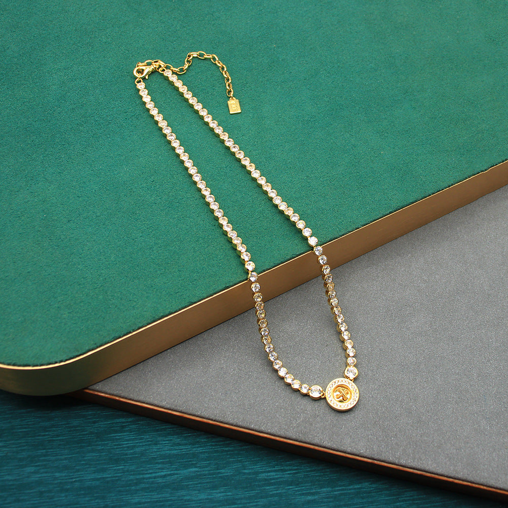 Gold-tone beaded chain necklace with round button pendant at end