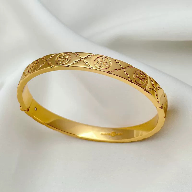 Gold hinged logo-pattern bangle bracelet with engraved oval motifs