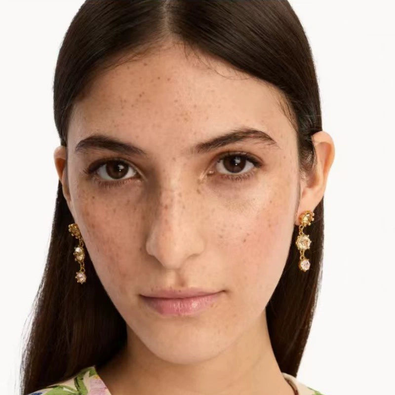 Gold-tone round crystal drop earrings with pink stones and dangling chain drops
