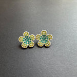 Gold diamond floral stud earrings with teal center and yellow-green stones