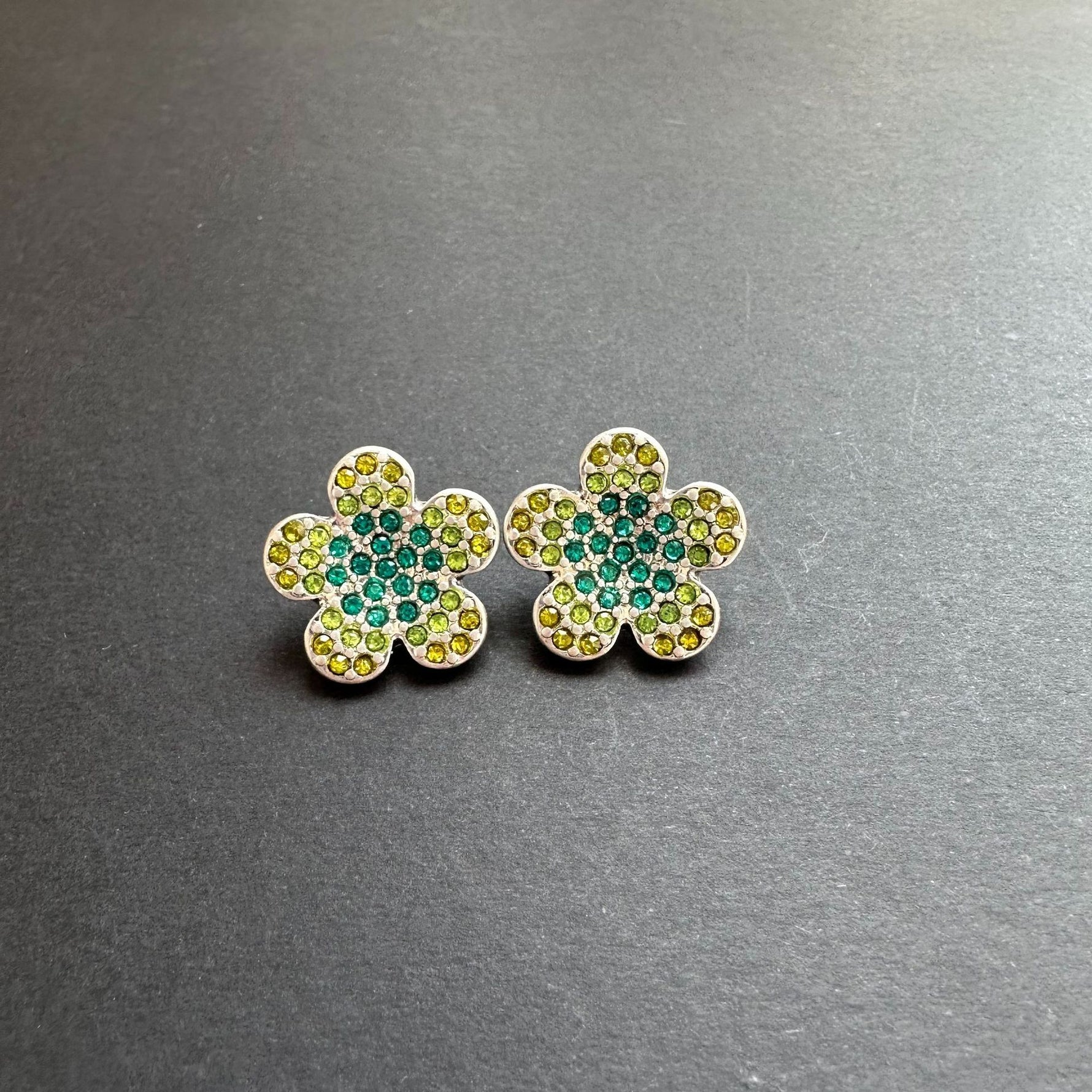 Gold diamond floral stud earrings with teal center and yellow-green stones