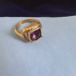 Square ring with purple gemstone set in textured gold and openwork band