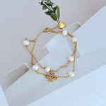 Gold double-layer bracelet with heart-shaped freshwater pearl charms and rhinestone bar