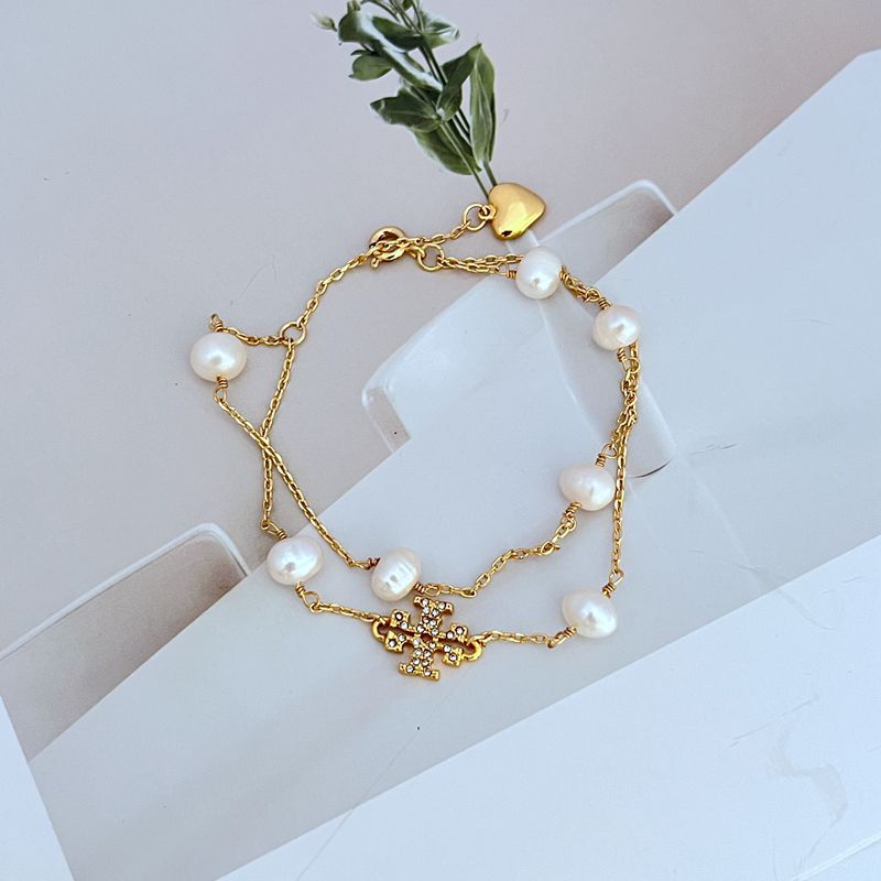 Gold double-layer bracelet with white freshwater pearls and heart charm drops