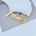 Milky White acrylic hair clip with gold logo clasp and teeth