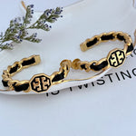 Leather-woven logo hoop earrings with black enamel and gold chain links