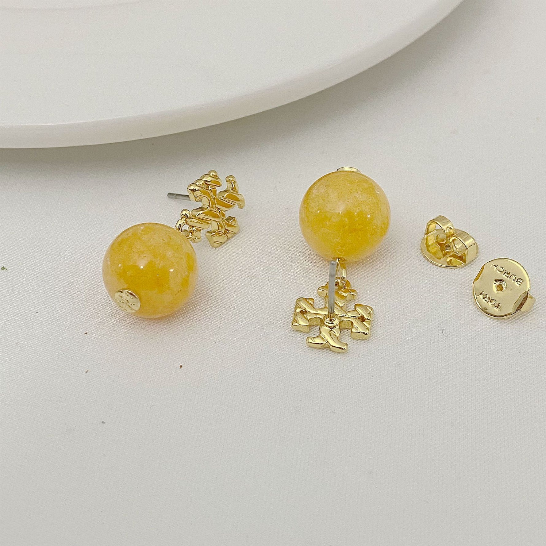 Yellow agate pendant earrings with gold logo stud and round bead drop