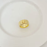 Gold-tone rhinestone letter inlay ring with engraved front panel and logo detail