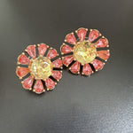 Sunburst flower stud earrings with pink teardrop stones, yellow center, gold-tone setting
