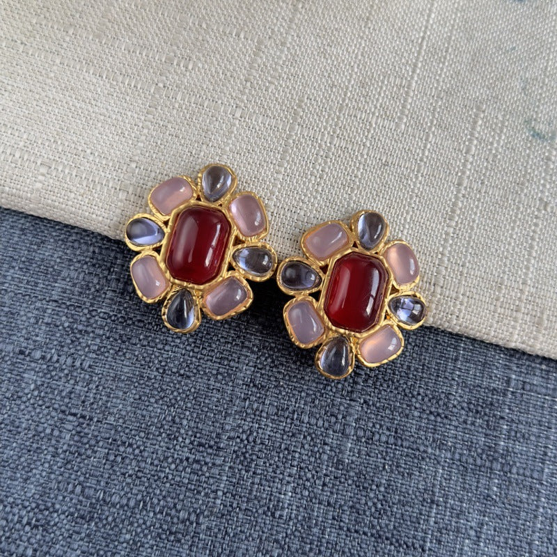 Vintage-style irregular clip-on crystal earrings: red center with pink and dark gray stones, gold-tone