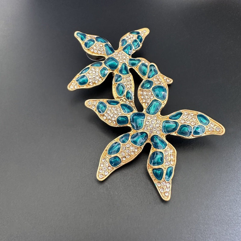 Starfish flower enamel earrings, blue teardrop spots with crystal accents, gold-tone