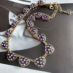 Purple rhinestone heart necklace with gold-tone links and heart-shaped sparkle charms