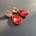 Teardrop-cut crystal stud earrings with red teardrop drops and red square tops, gold tone