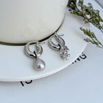 Asymmetrical pearl earrings in silver-tone with white pearl drops
