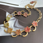 Gold-tone floral O-ring necklace with pink and red crystal flower charms