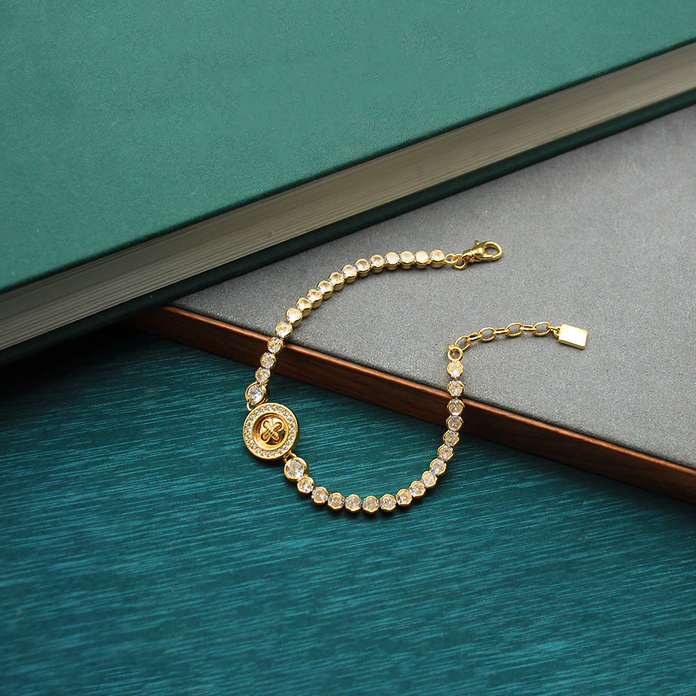 Gold-tone beaded bracelet with round coin clover charm and clasp