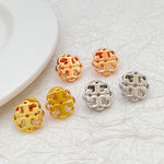 Set of metal logo stud earrings in gold, rose gold, and white gold tones